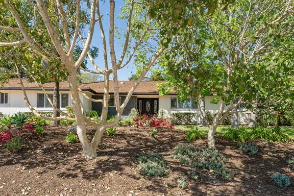 a view of a house with a flower garden