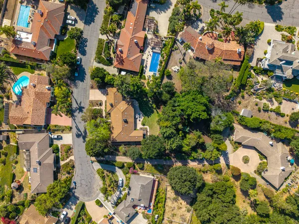 an aerial view of residential house with outdoor space and trees all around