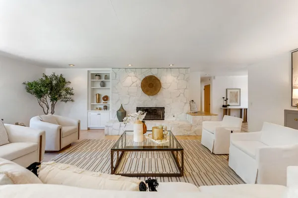a living room with furniture and a large window