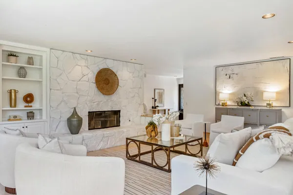 a living room with furniture and a fireplace