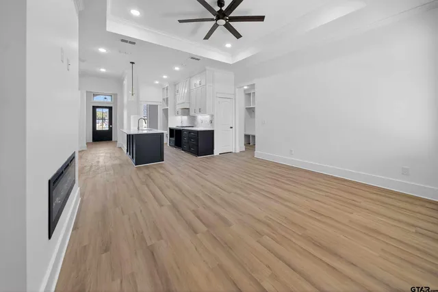 a view of kitchen with sink and refrigerator