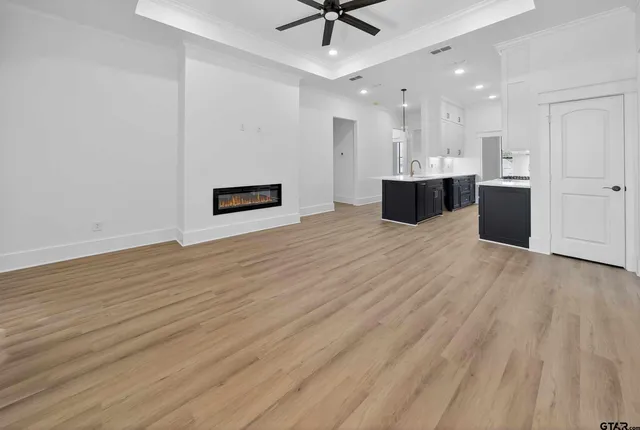 a view of kitchen and hall with wooden floor