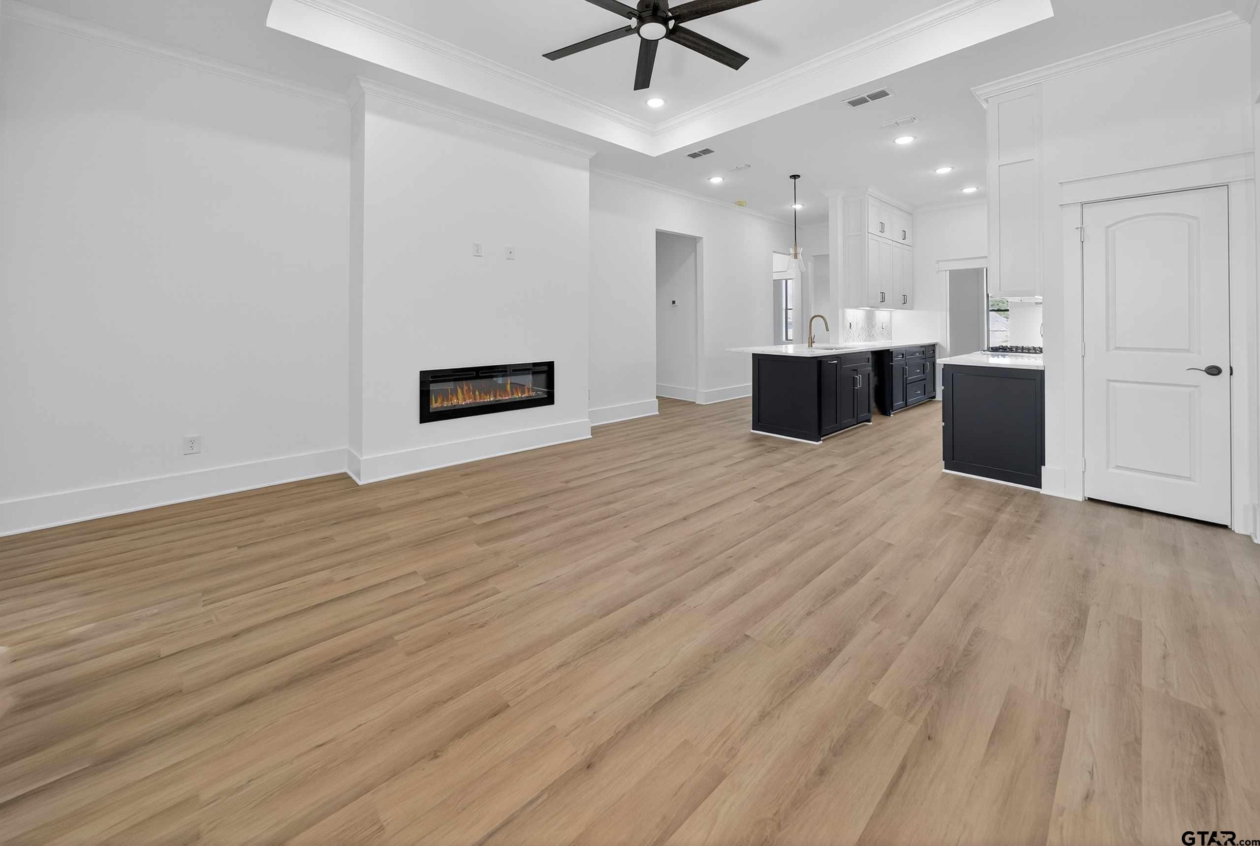 173 Sides Boulevard Bullard, TX 75757 - Photo 13 of 48 a view of kitchen and hall with wooden floor