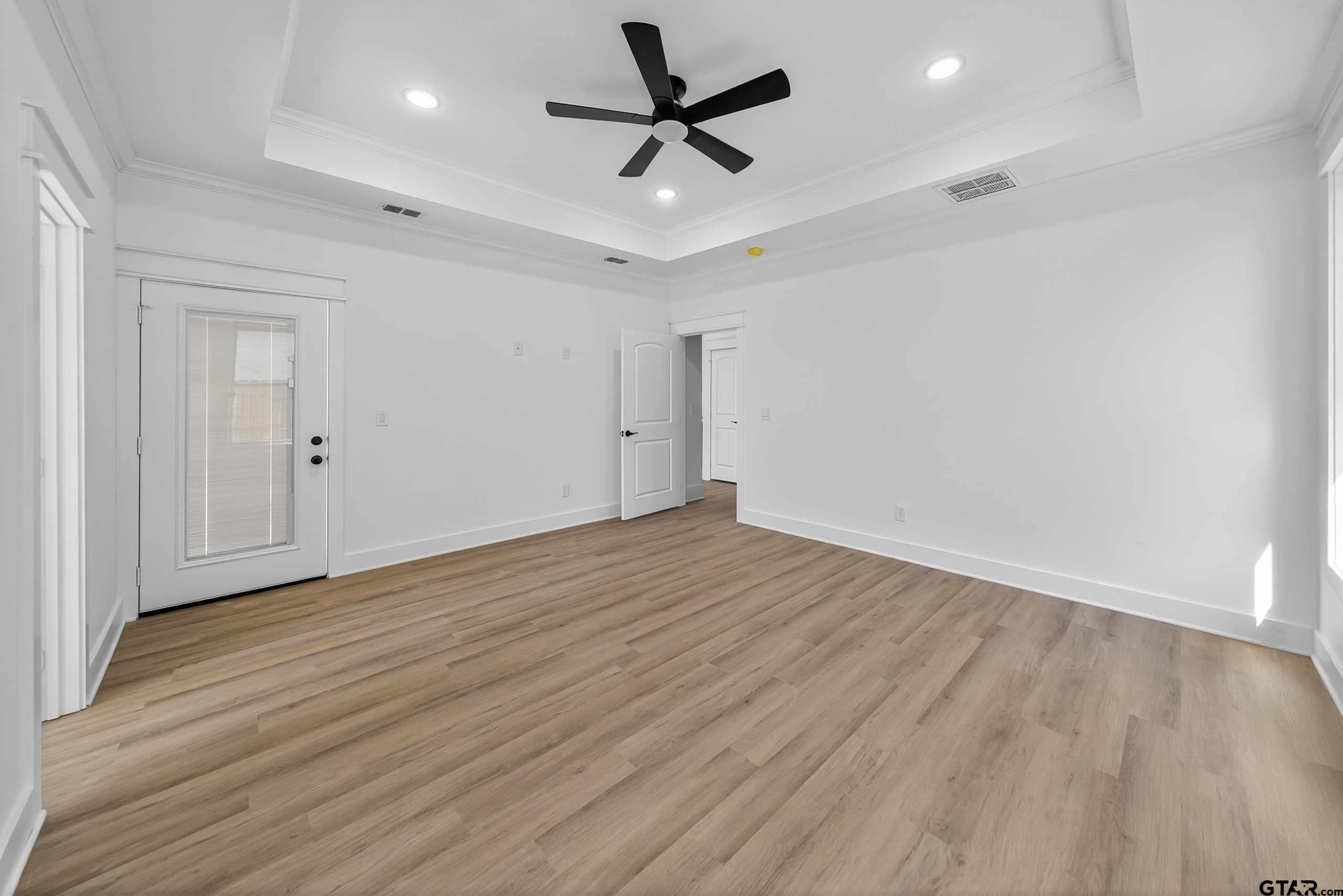 173 Sides Boulevard Bullard, TX 75757 - Photo 15 of 48 an empty room with wooden floor and ceiling fan