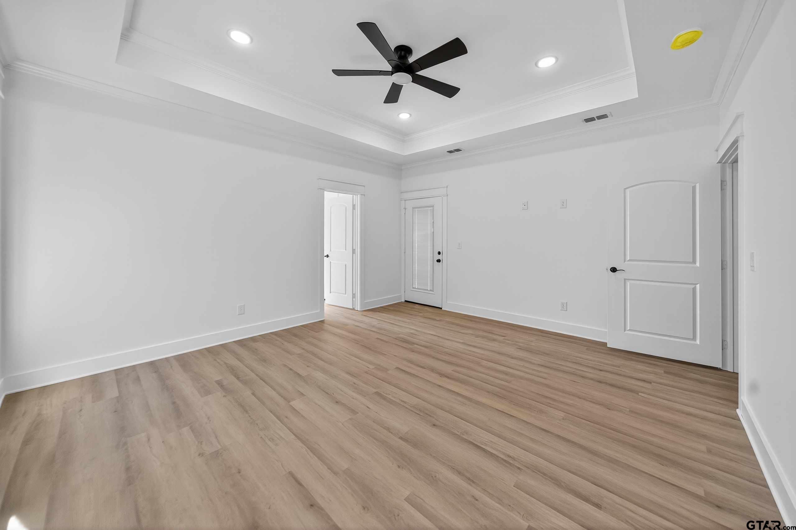 173 Sides Boulevard Bullard, TX 75757 - Photo 16 of 48 an empty room with wooden floor and ceiling fan
