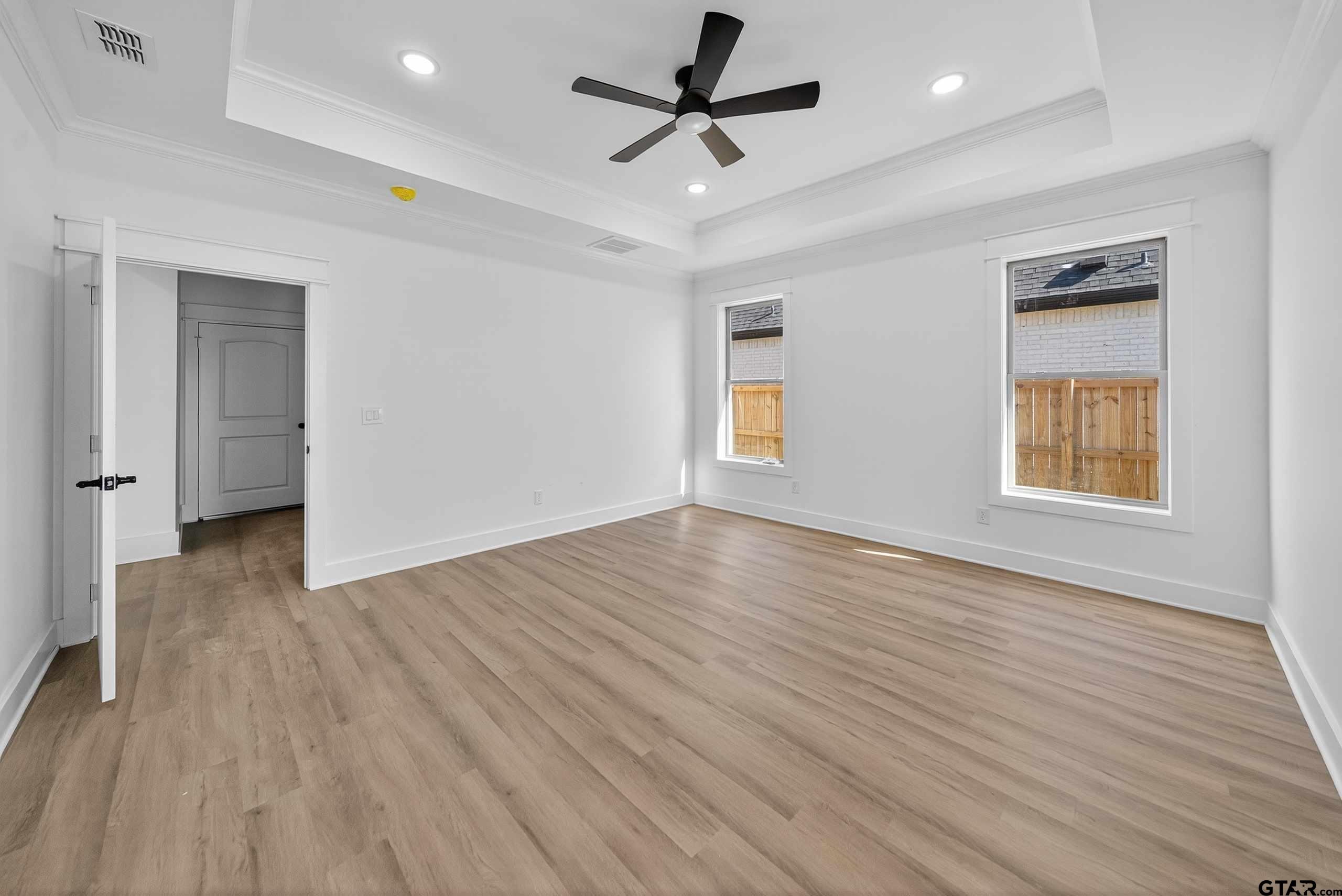 173 Sides Boulevard Bullard, TX 75757 - Photo 18 of 48 an empty room with wooden floor and windows