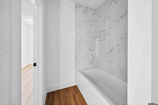 a bathroom with a bathtub and a toilet