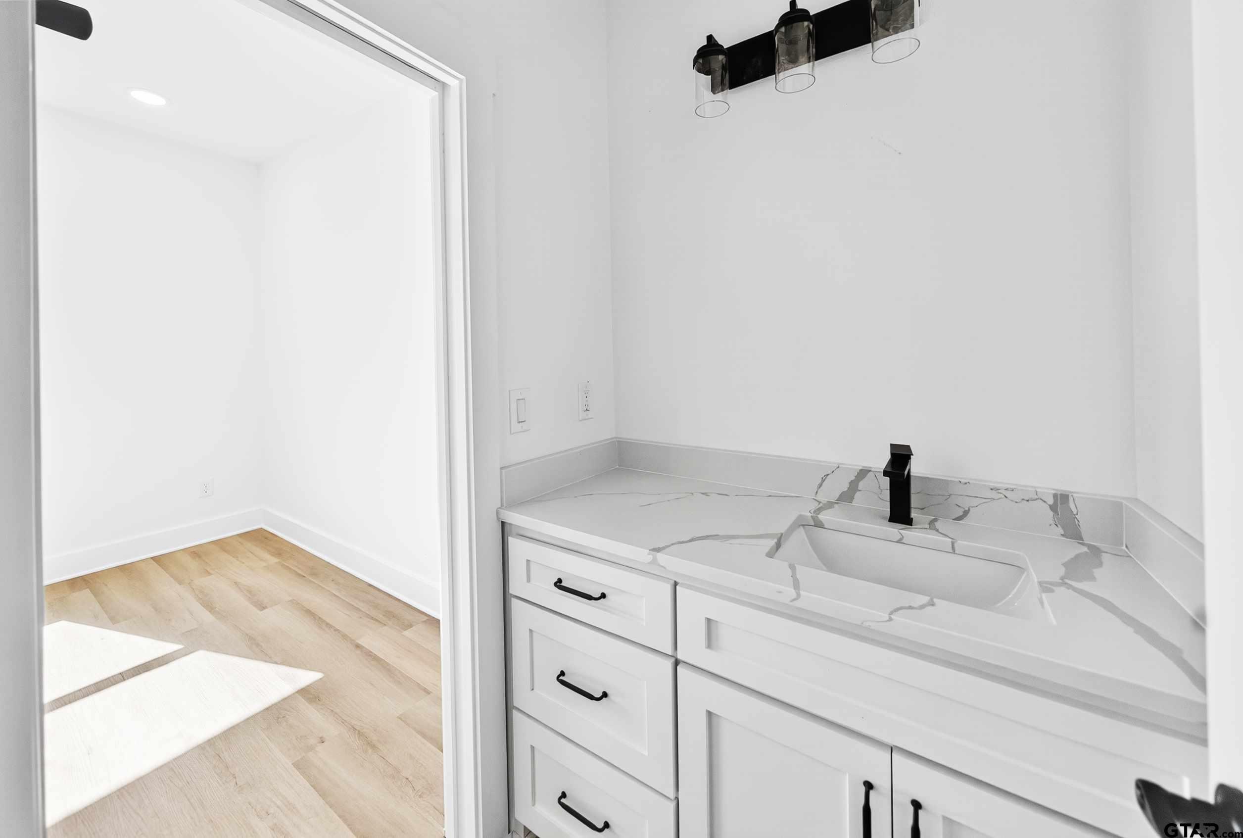 173 Sides Boulevard Bullard, TX 75757 - Photo 29 of 48 a bathroom with a granite countertop sink and a mirror