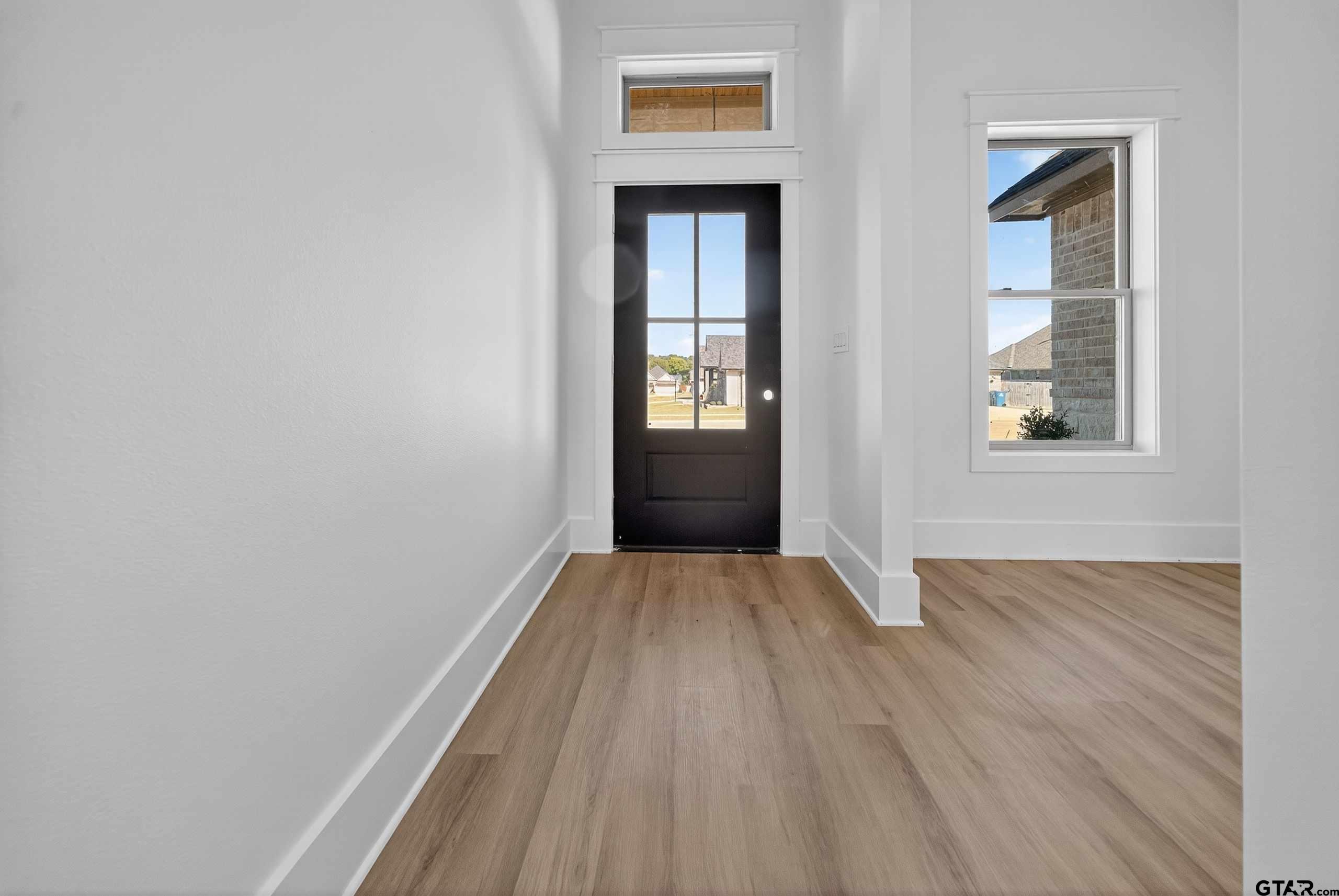 173 Sides Boulevard Bullard, TX 75757 - Photo 3 of 48 a view of an empty room with wooden floor and a window