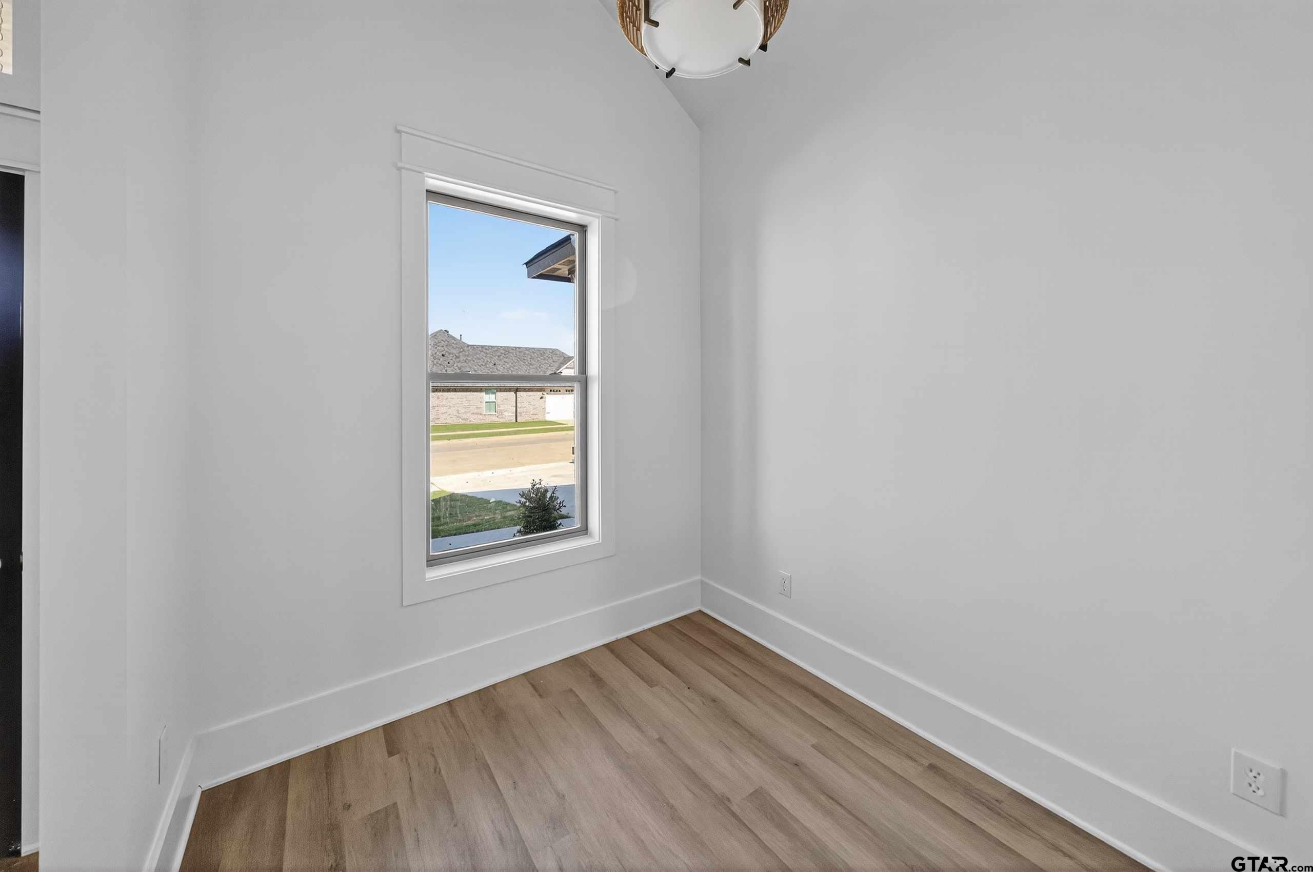 173 Sides Boulevard Bullard, TX 75757 - Photo 32 of 48 a view of an empty room with wooden floor and a window