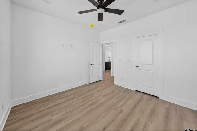 a kitchen with a sink cabinets and wooden floor