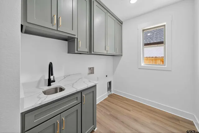 a kitchen with sink and cabinets
