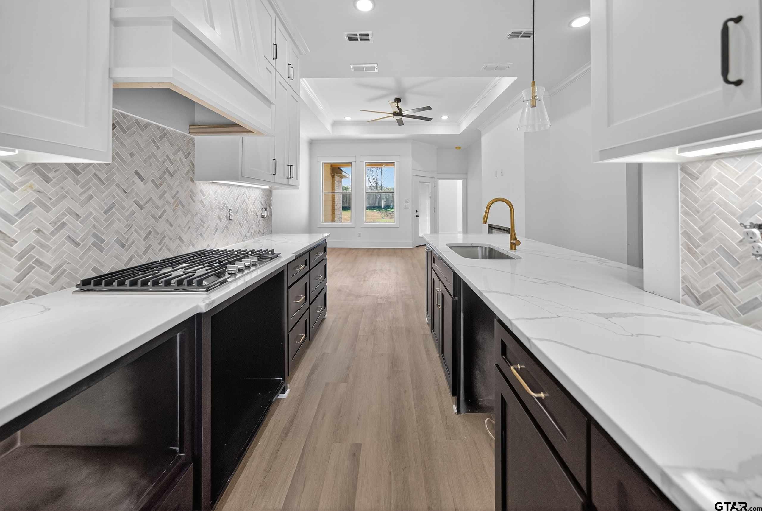 173 Sides Boulevard Bullard, TX 75757 - Photo 4 of 48 a kitchen with granite countertop a sink stove and cabinets