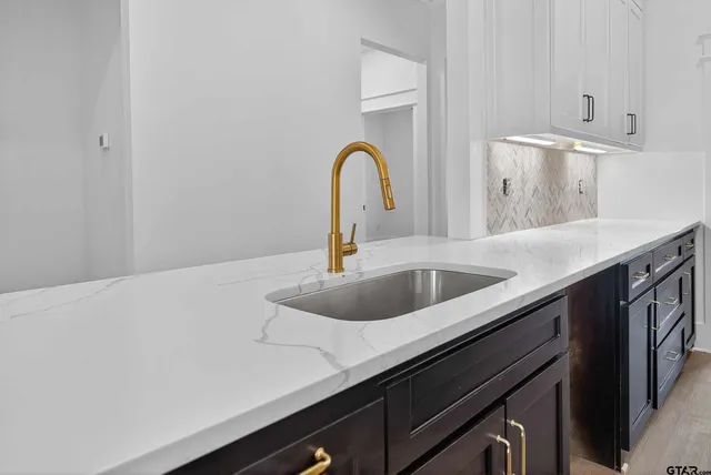a close view of a sink and dishwasher in a kitchen