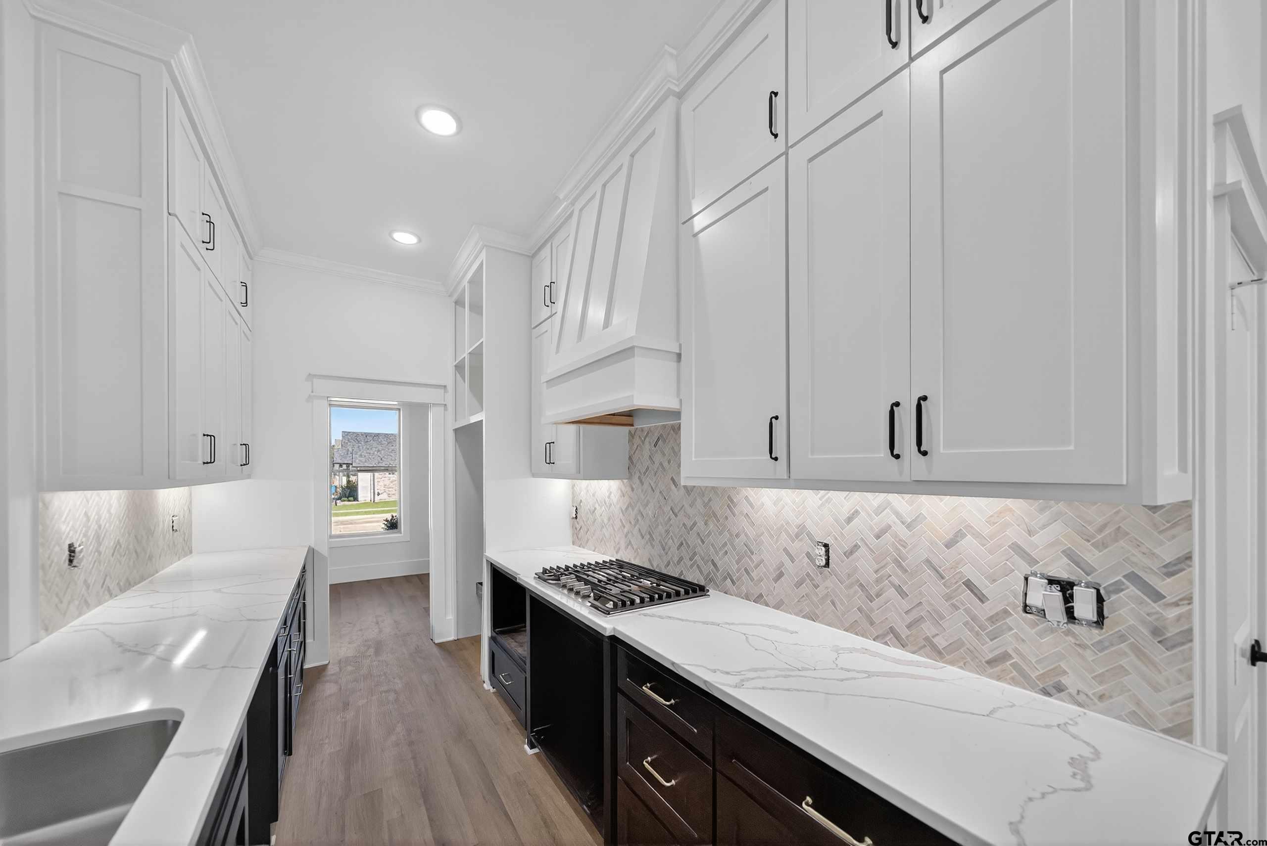 173 Sides Boulevard Bullard, TX 75757 - Photo 6 of 48 a kitchen with granite countertop a sink stove and cabinets