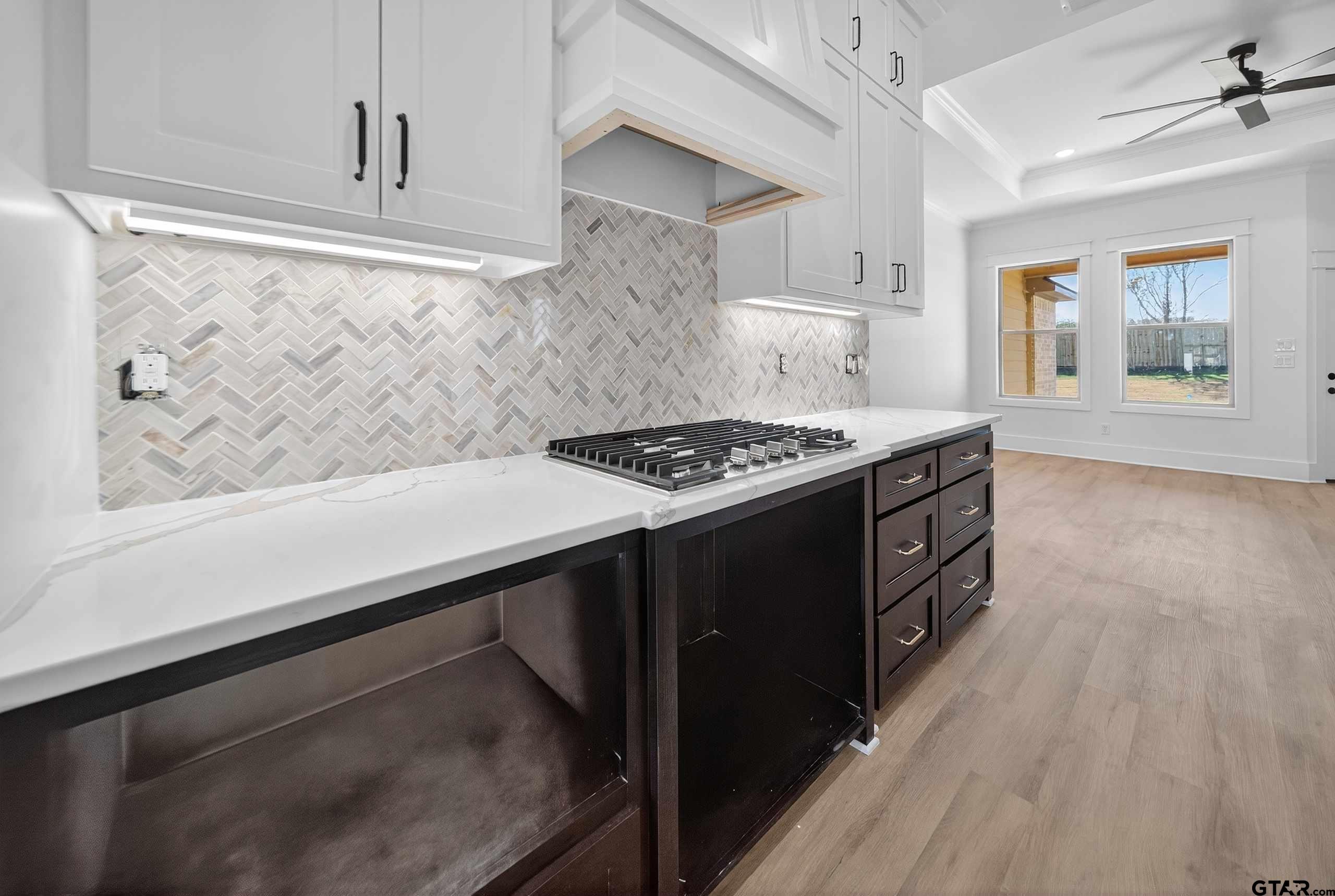 173 Sides Boulevard Bullard, TX 75757 - Photo 8 of 48 a kitchen with granite countertop a stove and a wooden floor