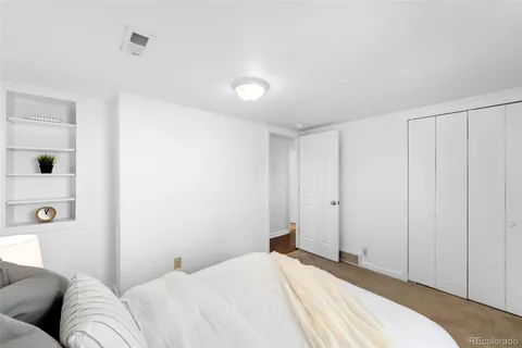 a bedroom with a bed and a couch