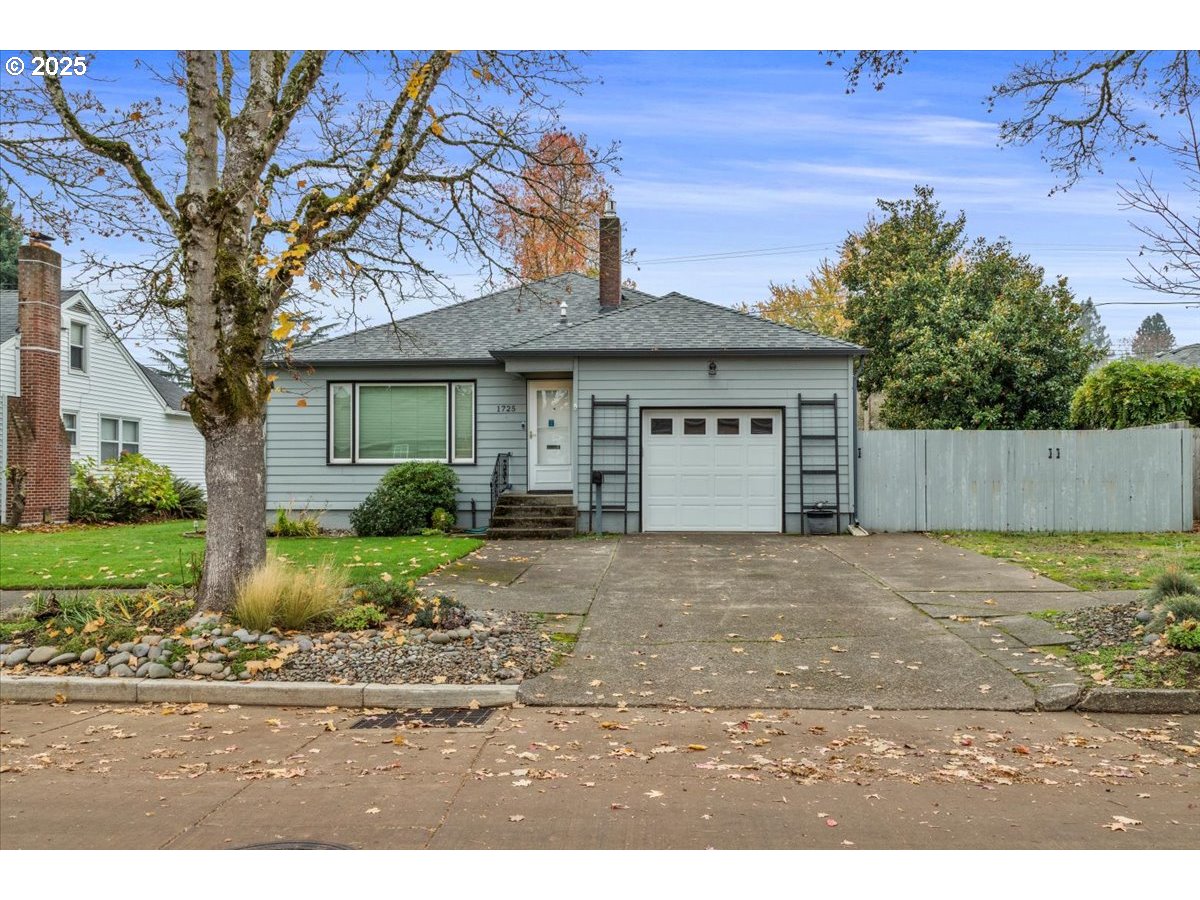 a front view of a house with a yard and a garage