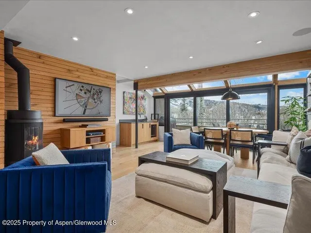 a living room with furniture and a floor to ceiling window