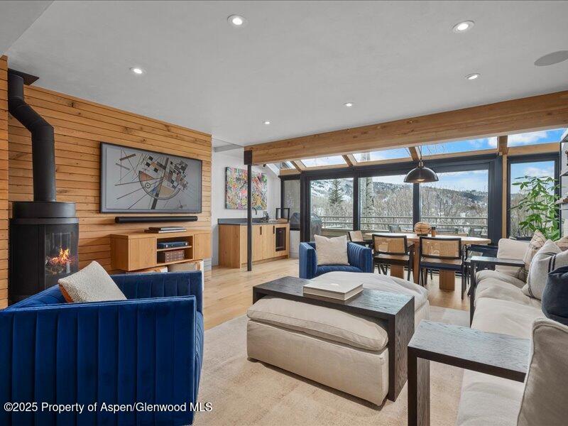 100 North 8th Street, Unit 15 Aspen, CO 81611 - Photo 1 of 27 a living room with furniture and a floor to ceiling window