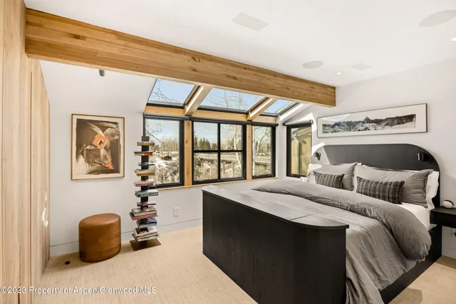 a bedroom with a bed and a large window