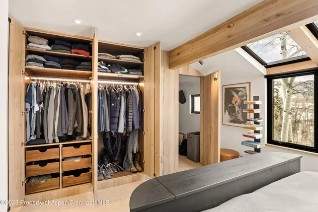 a living room with stainless steel appliances furniture and a window