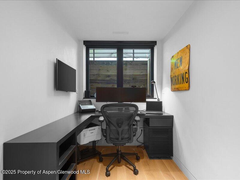 100 North 8th Street, Unit 15 Aspen, CO 81611 - Photo 19 of 27 a work room with furniture and a flat screen tv