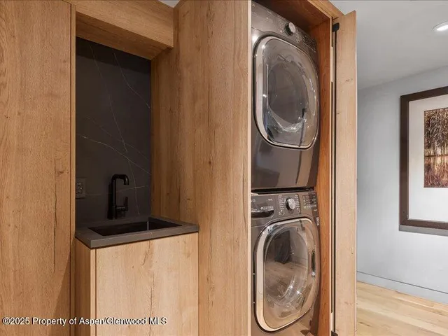 a view of a storage and utility room with washer and dryer