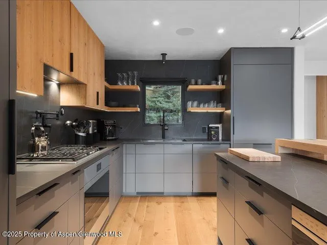 a kitchen with stainless steel appliances granite countertop a sink and a stove