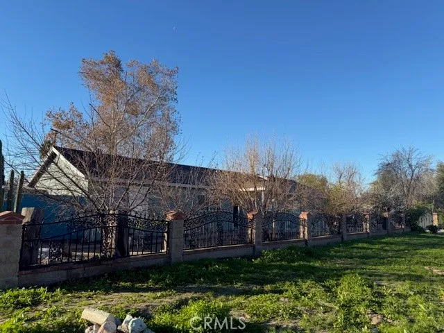 a view of a house with a yard and potted plants