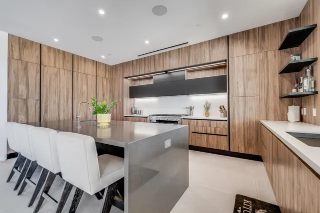 a kitchen with stainless steel appliances kitchen island granite countertop a sink and cabinets