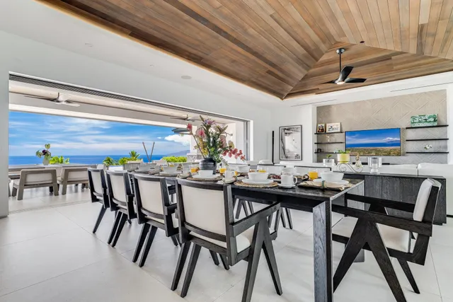 a view of a dining room with furniture and a potted plant