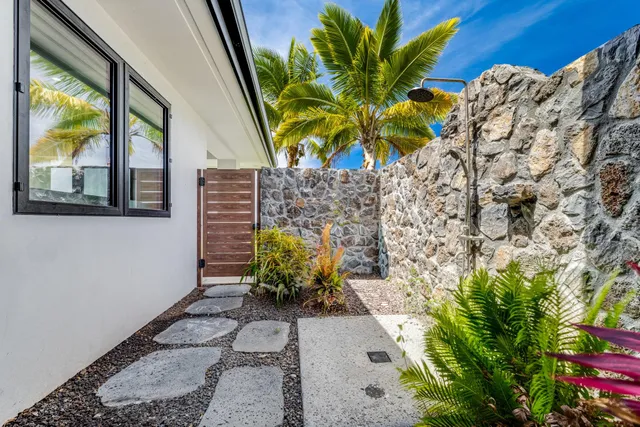 a bedroom with two beds and a large window