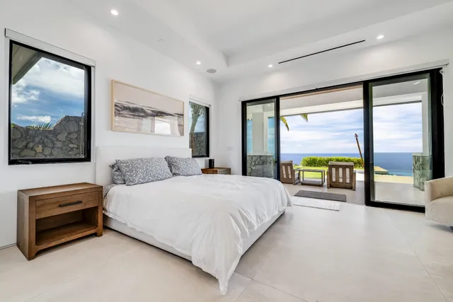 a bedroom with furniture and a large window