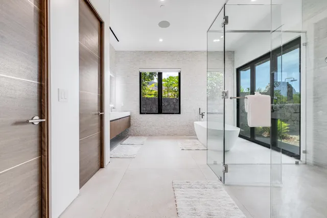 a bathroom with a tub sink and mirror
