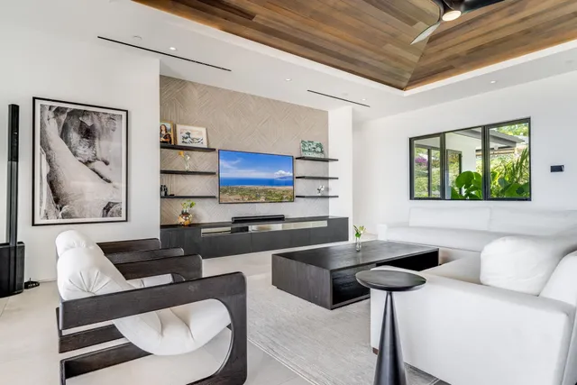 a kitchen with a table chairs a flat screen tv and a stove