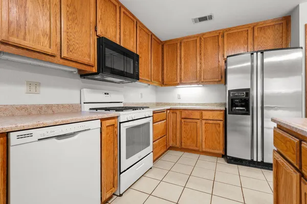 a kitchen with stainless steel appliances granite countertop a refrigerator sink and cabinets