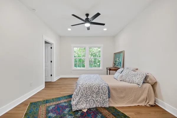a bedroom with a bed and a painting on the wall