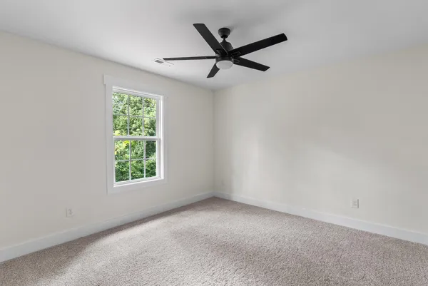 a view of a livingroom and a ceiling fan