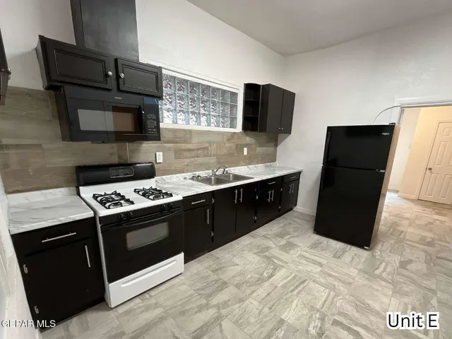 a kitchen with a stove and a refrigerator