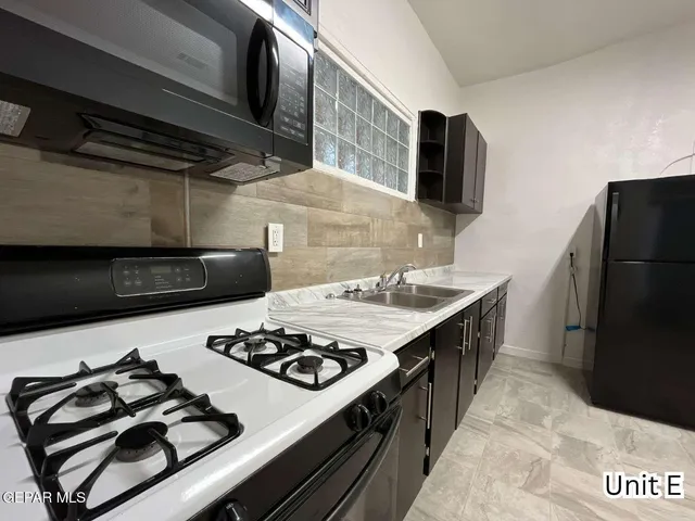 a kitchen with a stove and a refrigerator