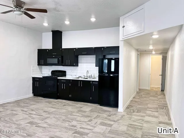 a kitchen with a refrigerator and a sink