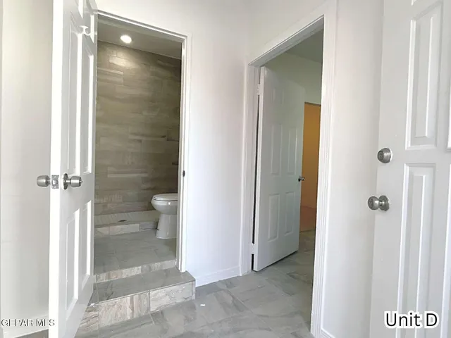 a bathroom with a glass shower door