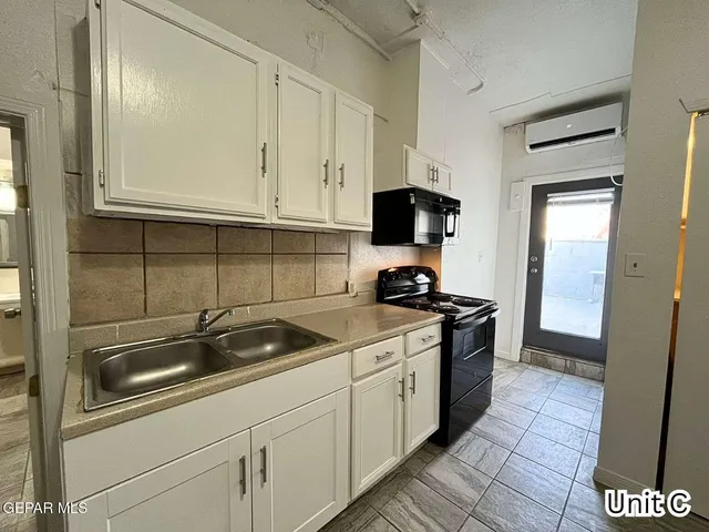 a kitchen with a sink and cabinets