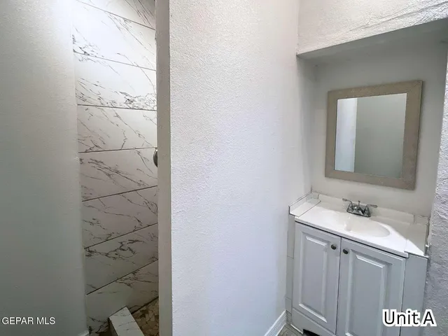 a bathroom with a sink mirror and vanity