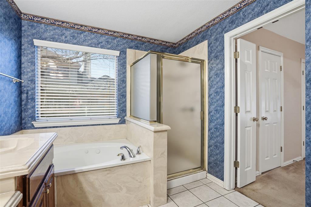 231 Bluff View Court Aledo, TX 76008 - Photo 16 of 34 a bathroom with a tub a sink and a window