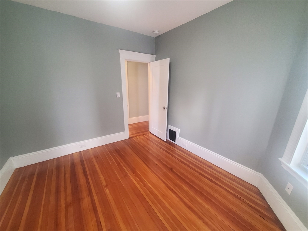 14 North Munroe Terrace, Unit 2 Boston, MA 02122 - Photo 14 of 19 a view of empty room with wooden floor