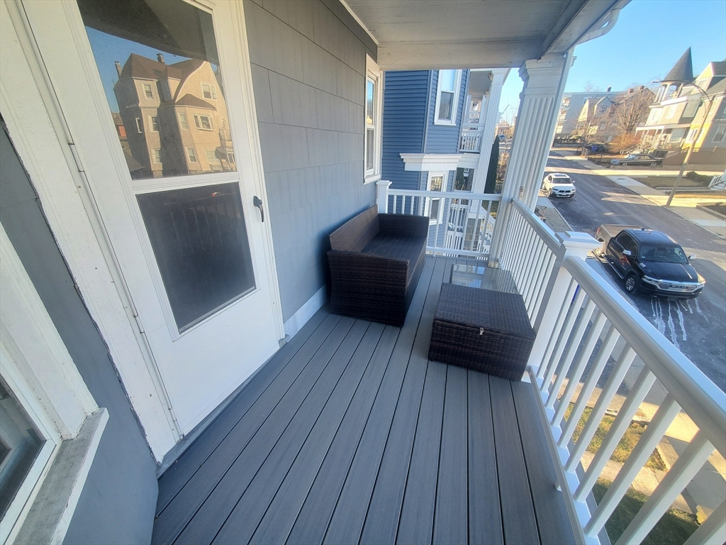 14 North Munroe Terrace, Unit 2 Boston, MA 02122 - Photo 17 of 19 a living room with furniture and a wooden floor