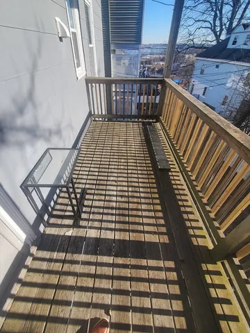 a view of a balcony with wooden floor