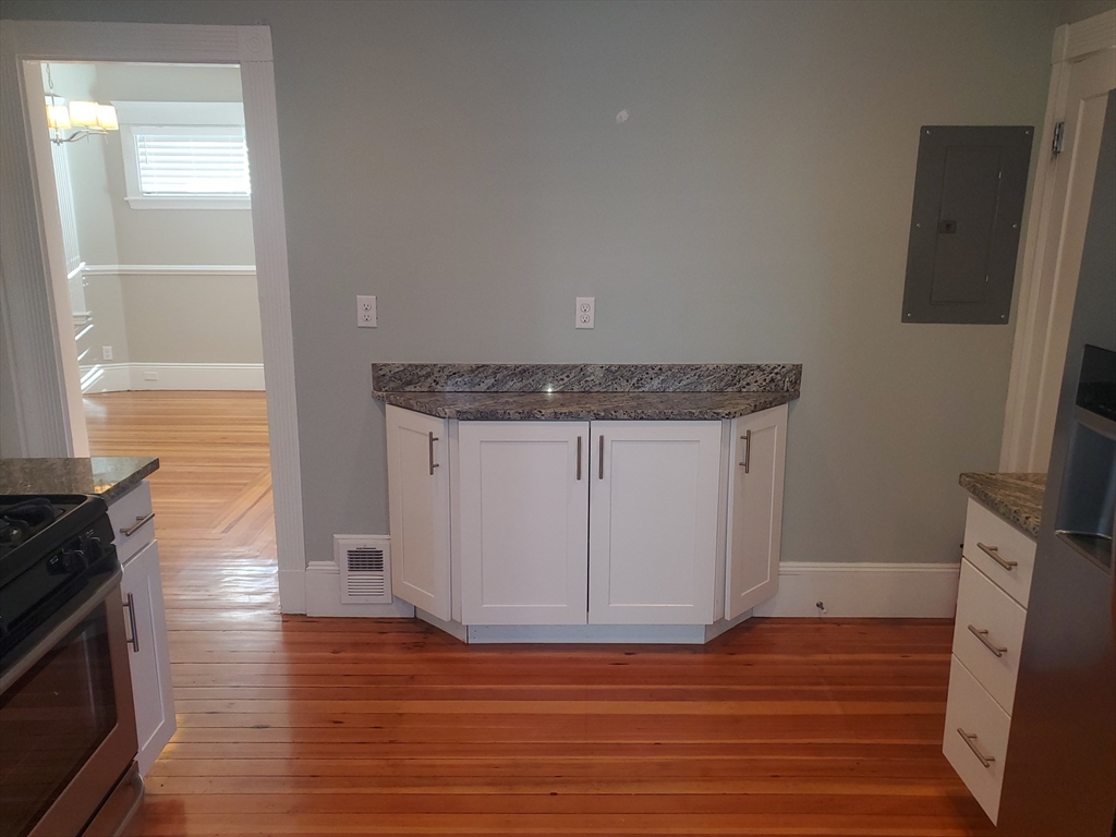 14 North Munroe Terrace, Unit 2 Boston, MA 02122 - Photo 5 of 19 a view of a kitchen with wooden floor and a sink